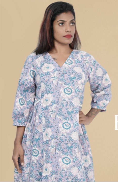 Woman wearing a floral dress with text 'Durable Everyday Wear' and a plant in the background.